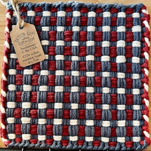 May include: Red, white, and blue woven pot holder with a tag that reads "KRISTIN KAY'S velee LOOPSON 100M handwoven in the USA 100% cotton machine wash dry flat"