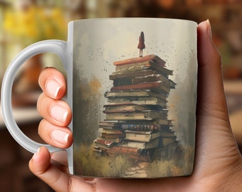 May include: White ceramic mug with a colorful illustration of a stack of books with a small figure standing on top. The books are stacked high and the figure is small in comparison. The background is a blurred image of a forest.