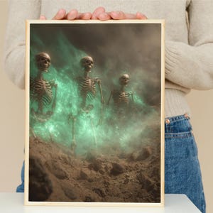 May include: A framed print featuring three skeletal figures emerging from a misty, green-tinged environment. The skeletons are detailed with visible rib cages and skulls, set against a dark, atmospheric backdrop. The artwork evokes a sense of mystery.