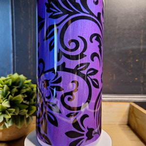 May include: A purple and black stainless steel tumbler with a damask pattern.