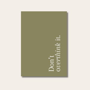 May include: A rectangular olive green print with the words "Don't overthink it" in white script. The print is set against a cream-colored background.