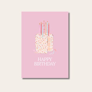Könnte beinhalten: Rosa Geburtstagskarte mit einer Kuchenillustration, verziert mit bunten Streuseln und Kerzen. Ein Stück ist herausgeschnitten. Die Worte "HAPPY BIRTHDAY" sind unten auf der Karte in Weiß gedruckt.