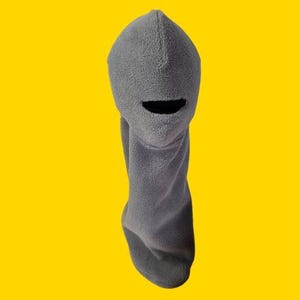 May include: Gray fleece balaclava with a hole for the mouth and nose.
