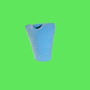 May include: A light blue ceramic vase with a unique, wavy design. The vase is empty and has a smooth, matte finish.