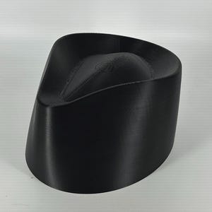 May include: A black, 3D printed, hat-shaped object with a rounded top and a slightly curved brim.