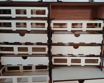 May include: A wooden storage box with a carrying handle, featuring multiple drawers and compartments. The box is open, revealing the interior organization.