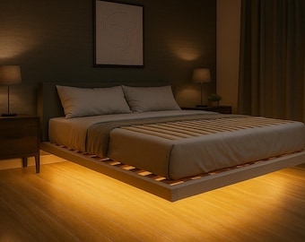 May include: A contemporary bedroom with a low bed frame and wooden slats, dressed with neutral-coloured bedding. Two bedside tables with lamps are positioned on either side of the bed. The room is softly lit, creating a warm and inviting atmosphere.