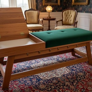 May include: A wooden bench with a hinged top and a green upholstered seat. The bench has a light brown finish and is supported by angled legs. The seat is tufted with four buttons. The bench is 60 inches long.