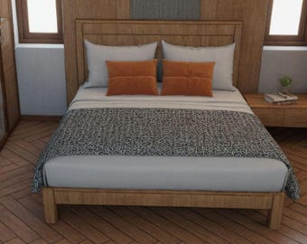 May include: A wooden bed frame with a white headboard and a grey and white patterned bedspread. The bed has two orange throw pillows and is set against a wood-panelled wall.