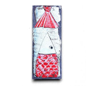 May include: A ceramic tile with a hand-painted design of a fish with red scales and a white body. The fish is wearing a red hat.