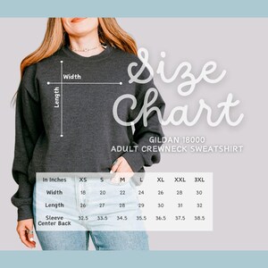 May include: Size chart for Gildan 18000 adult crewneck sweatshirt. The chart shows measurements in inches for width, length, sleeve, and center back for sizes XS to 3XL.