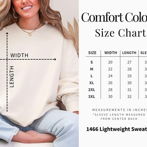 May include: Size chart for a Comfort Colors 1466 Lightweight Sweatshirt. The chart shows the width, length, and sleeve length in inches for sizes S through 3XL.
