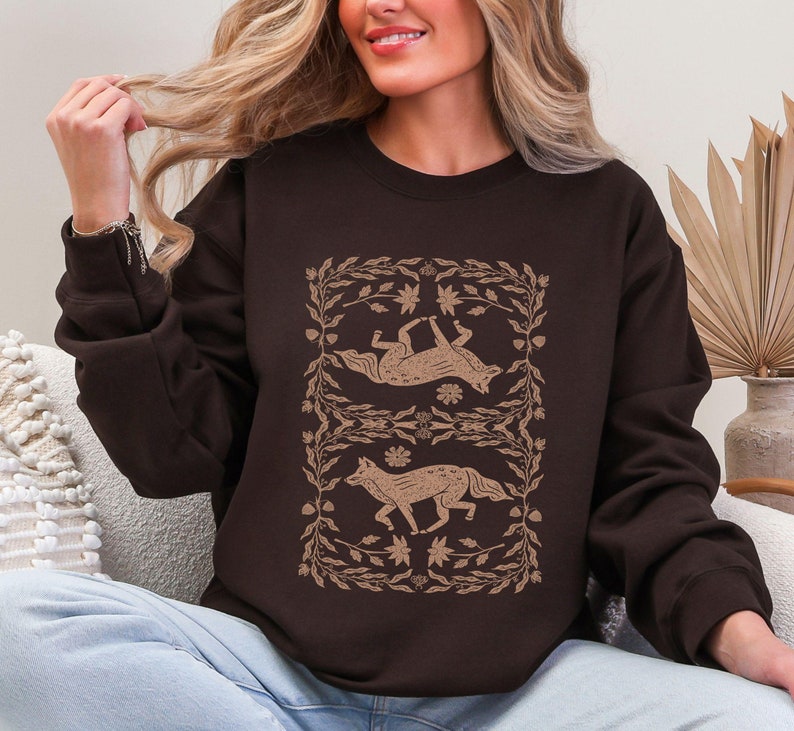 symmetrical fox linocut style in brown on the front of a sweatshirt