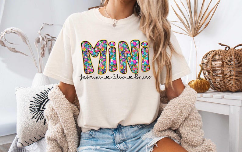 May include: A white t-shirt with the word "MINI" in colorful floral letters. The names "Jasmine", "Alex", and "Bruno" are written below the word "MINI" in black.