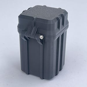 May include: A black, square-shaped, plastic storage container with a textured lid and a latch.
