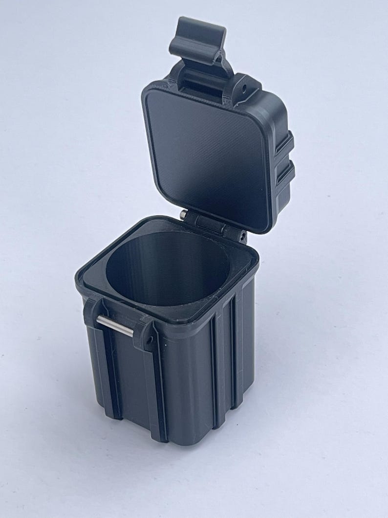 May include: A black plastic storage container with a hinged lid and a latch. The container is open and the lid is propped up.