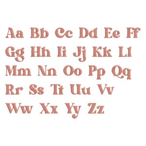 May include: A set of uppercase letters in a cursive font, in a peachy-pink colour. The letters are arranged in alphabetical order.