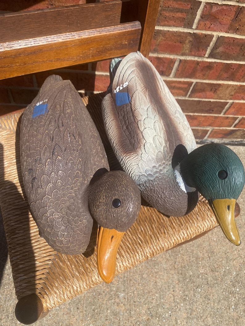 Side profile of drake mallard duck decoy featuring green head white neck ring gray feathered body and blue wing accent, vintage Flambeau molded plastic hunting decoy with realistic sculpted feather texture, functional floating decoy with weighted keel underside, rustic lodge decor and Ralph Lauren cabin style inspiration, lake house display piece with sporting heritage, aged patina and paint wear visible, outdoorsman decor collectible suitable for shelf styling or hunting use