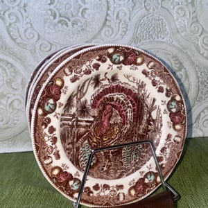 May include: A set of three ceramic mugs with a speckled, matte finish. The mugs are in shades of cream, light gray, and dark gray. Each mug has a simple, minimalist design, perfect for coffee or tea.