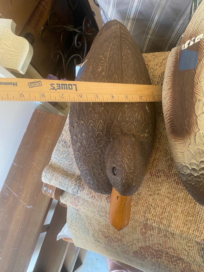 Top view of hen mallard duck decoy highlighting layered feather pattern across back and wings with subtle painted detailing and natural brown color variation, vintage Flambeau hunting decoy with realistic molded plastic texture, functional floating waterfowl decoy with weighted keel underside not visible, rustic lodge decor styling for cabin or lake house, sporting decor collectible with authentic patina and wear, wildlife themed accent piece blending utility and decorative appeal