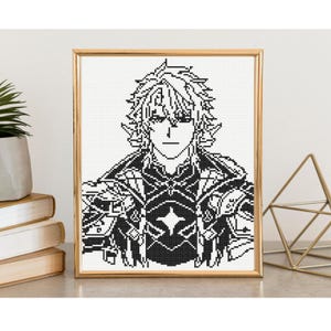 May include: A framed cross-stitch portrait of an anime-style character with spiky hair, wearing detailed armor. The artwork is rendered in black and white, set against a white background, and framed in gold.