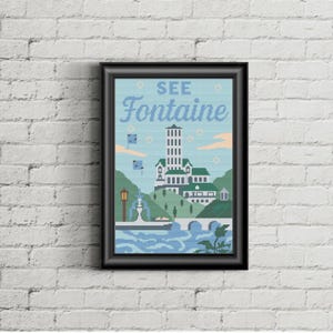 May include: A framed art print featuring a cross-stitch design of a building with a tall tower, set against a light blue sky. The text "SEE Fontaine" is at the top. The artwork is framed in a black frame and hangs on a white brick wall.