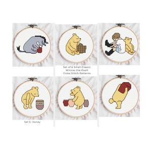May include: Set of six Winnie-the-Pooh cross-stitch patterns in embroidery hoops. Each features a different scene with characters like Eeyore and Winnie the Pooh. The text "Set of 6 Small Classic Winnie-the-Pooh Cross Stitch Patterns" is visible.