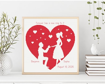 Puede incluir: Una pieza de arte en punto de cruz con marco cuadrado que presenta un gran corazón rojo con siluetas blancas de una persona arrodillada para proponer matrimonio. El texto dice Forever has a nice ring to it, Benjamin, Sophie y 16 de agosto de 2026.