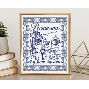 May include: A framed cross-stitch embroidery featuring a dark blue design on a white background. The artwork depicts a couple in historical attire, a domed building, and the text Persuasion By Jane Austen, all enclosed in a geometric border.