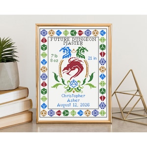 May include: Cross-stitch artwork in a gold frame, featuring a dragon design and the text "FUTURE DUNGEON MASTER." It includes the baby's weight, height, name, and birthdate. The artwork is surrounded by geometric shapes in various colors.