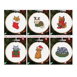 May include: Set of six Christmas cat ornament cross-stitch patterns. Each pattern is displayed in a wooden embroidery hoop. The cats are depicted in various festive scenes, including a stocking, a sweater, and a Santa hat. The text "Set of 6 Christmas Cat Ornament Cross Stitch Patterns 2 of 2" is visible.