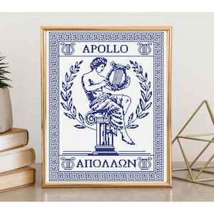 May include: A framed cross-stitch pattern featuring a dark blue design on a white background. The image depicts a figure playing a lyre while seated on a pillar, framed by laurel branches and a Greek key border. The text reads APOLLO and ΑΠΟΛΛΩΝ.