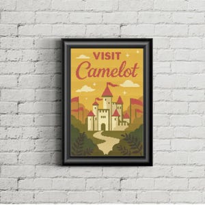 May include: Framed art print featuring a stylized illustration of a castle with red flags and towers, set against a yellow sky. The text "VISIT Camelot" is displayed at the top. The artwork is framed in a black border.