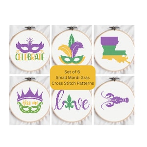 May include: A set of six small Mardi Gras cross stitch patterns in embroidery hoops. Designs include masks, feathers, the Louisiana state outline, a crown, the word "love", and a crawfish, in purple, green, and gold.