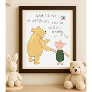 May include: A framed cross-stitch featuring Winnie the Pooh and Piglet, with the text "What I like best is me and Piglet going to see you and it being a hummy sort of day." A stuffed bunny and teddy bear are in the foreground.