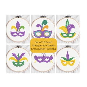 May include: Set of 12 small masquerade mask cross stitch patterns. Each pattern is displayed in a wooden embroidery hoop. The masks are in various colors, including purple, green, and yellow. The text "Set of 12 Small Masquerade Masks Cross Stitch Patterns" is in a yellow rectangle.