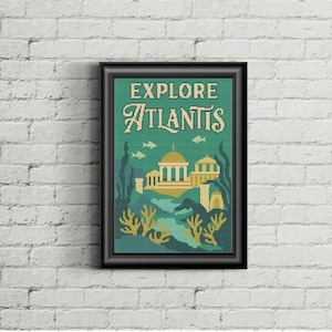 May include: A framed art print with the words "EXPLORE ATLANTIS" in a vintage style. The artwork features a teal and gold underwater scene with buildings, fish, and coral. The frame is black.