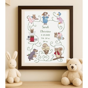 May include: Framed cross-stitch artwork featuring a name, date, and weight, surrounded by whimsical animal illustrations. The artwork includes the name "Sarah Christine", the date "8-23-2026", weight "7 lb 10 oz", and a length of "20 in".