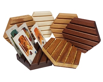 May include: Set of six hexagonal wooden card holders in various wood tones. The holders have grooves to hold cards upright. One holder has three cards in it.