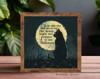 May include: Square wooden framed art print featuring a black cat silhouette against a full moon. The artwork includes the text "In the night when black cats are seen, the moon laughs and whispers tis near Halloween."