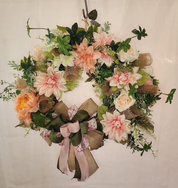pink and peach colored floral on this beautiful grapevine wreath