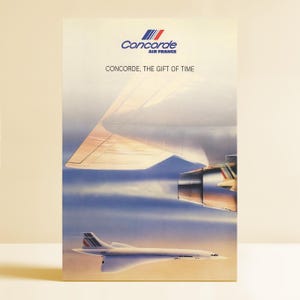May include: A vintage Air France Concorde advertisement. The image features a Concorde jet in flight, with a wing and engine visible. The text reads "Concorde, The Gift of Time" and the Air France logo is at the top.