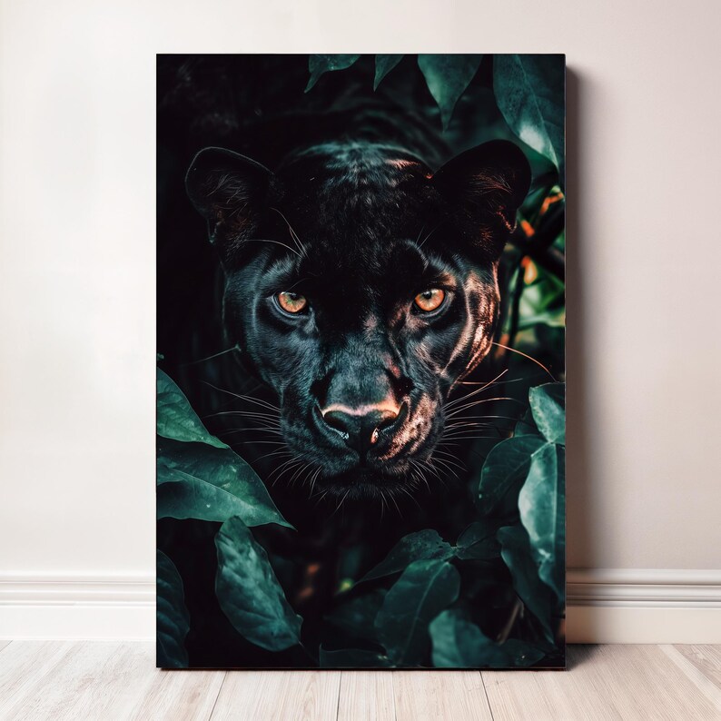 May include: A framed canvas print featuring a close-up of a black panther's face, with piercing yellow eyes. The panther is partially obscured by lush, green foliage, creating a dramatic contrast. The artwork is set against a neutral wall.