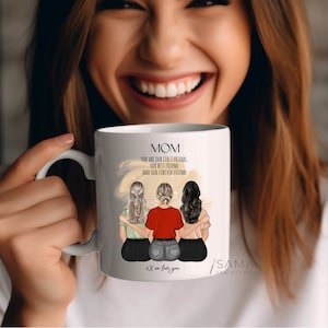 May include: White ceramic mug with a black handle. The mug has a graphic of three women with long hair, wearing different outfits. The text on the mug reads "MOM You are our first friend, our best friend and our forever friend. We love you."