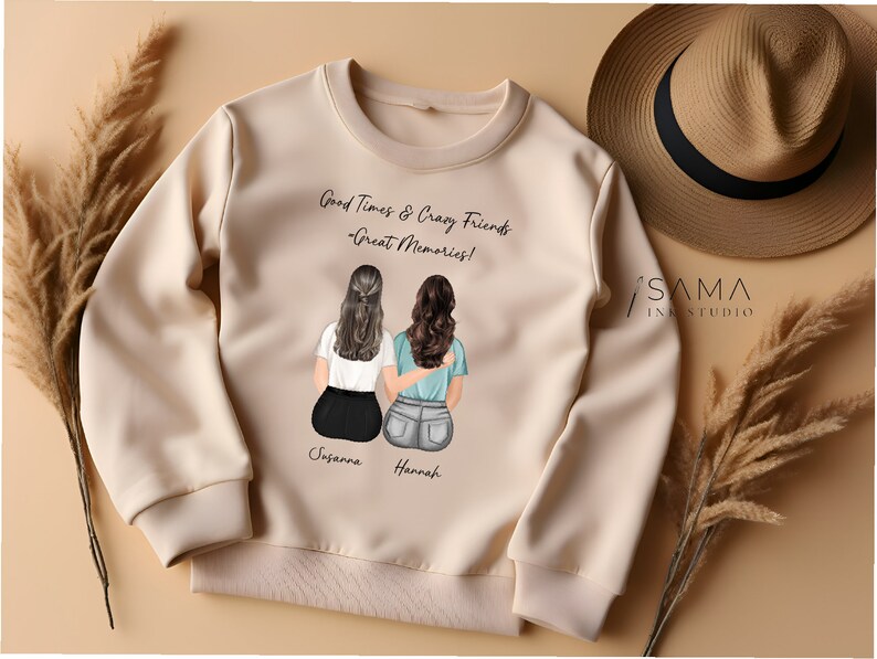May include: A beige sweatshirt with a graphic of two women sitting back to back. The text on the sweatshirt reads "Good Times & Crazy Friends - Great Memories!" and includes the names "Susanna" and "Hannah".