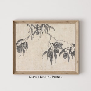 May include: A black and white ink painting of a branch with leaves and fruit. The painting is on a beige background and is framed in a light wood frame. The text "DEPICT DIGITAL PRINTS" is at the bottom of the frame.
