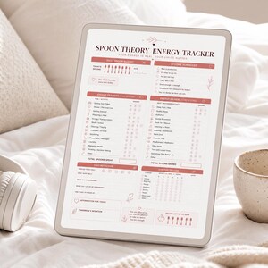 May include: A digital tablet displaying a Spoon Theory Energy Tracker template with a soft pink and white color scheme. The layout includes sections for daily spoon budget, energy drainers, energy gainers, symptom tracking, and daily reflections.