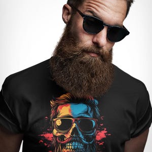 May include: Black t-shirt featuring a colorful skull design with sunglasses, a mustache, and a beard. The graphic has blue, yellow, red, and orange accents. The t-shirt is a crew neck style.