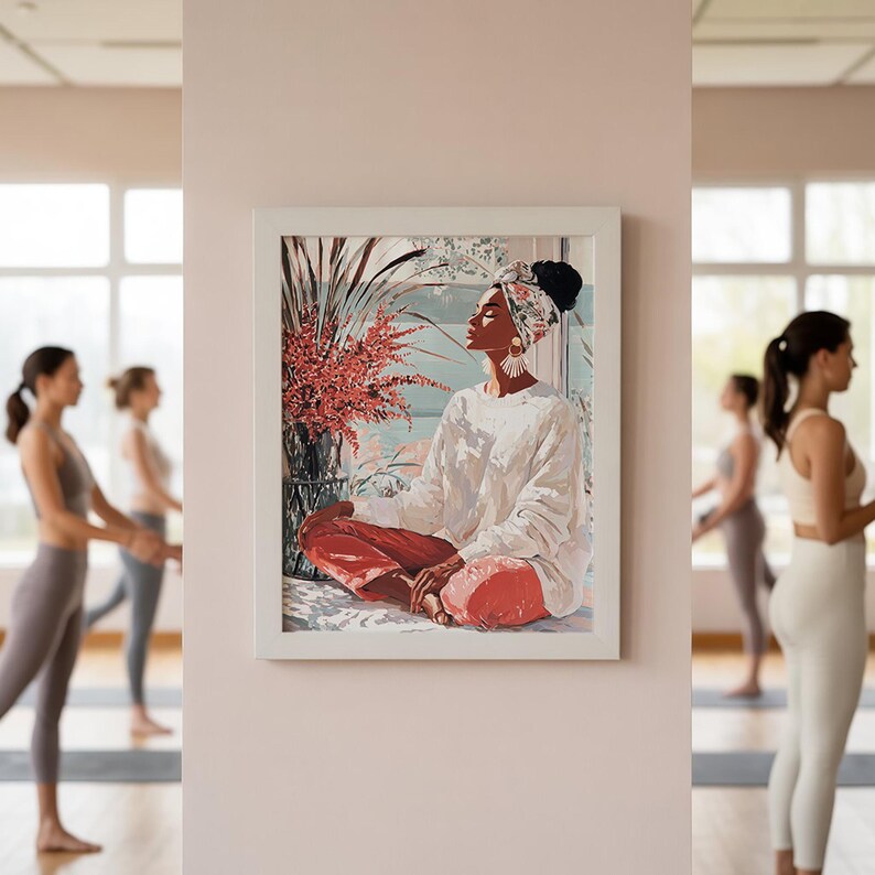May include: A framed art print depicts a person in a white sweater and red pants, seated in a meditative pose. The artwork features a floral arrangement and a window view. The background shows people practicing yoga.