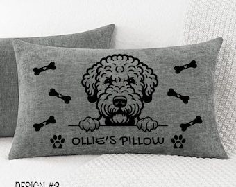 May include: Gray rectangular pillow with a black dog illustration, bone accents, and the text "Ollie's Pillow." The design includes paw prints and the text "DESIGN #3" at the bottom. The pillow is on a white surface.